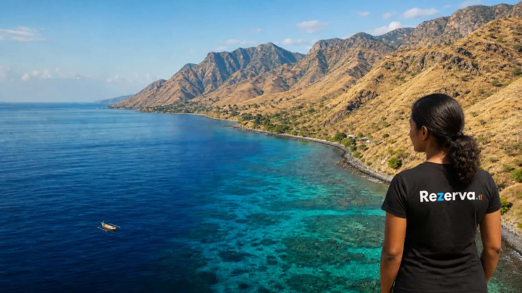 Young Timorese woman in a Rezerva shirt looking across Ataúro Island's reef coast