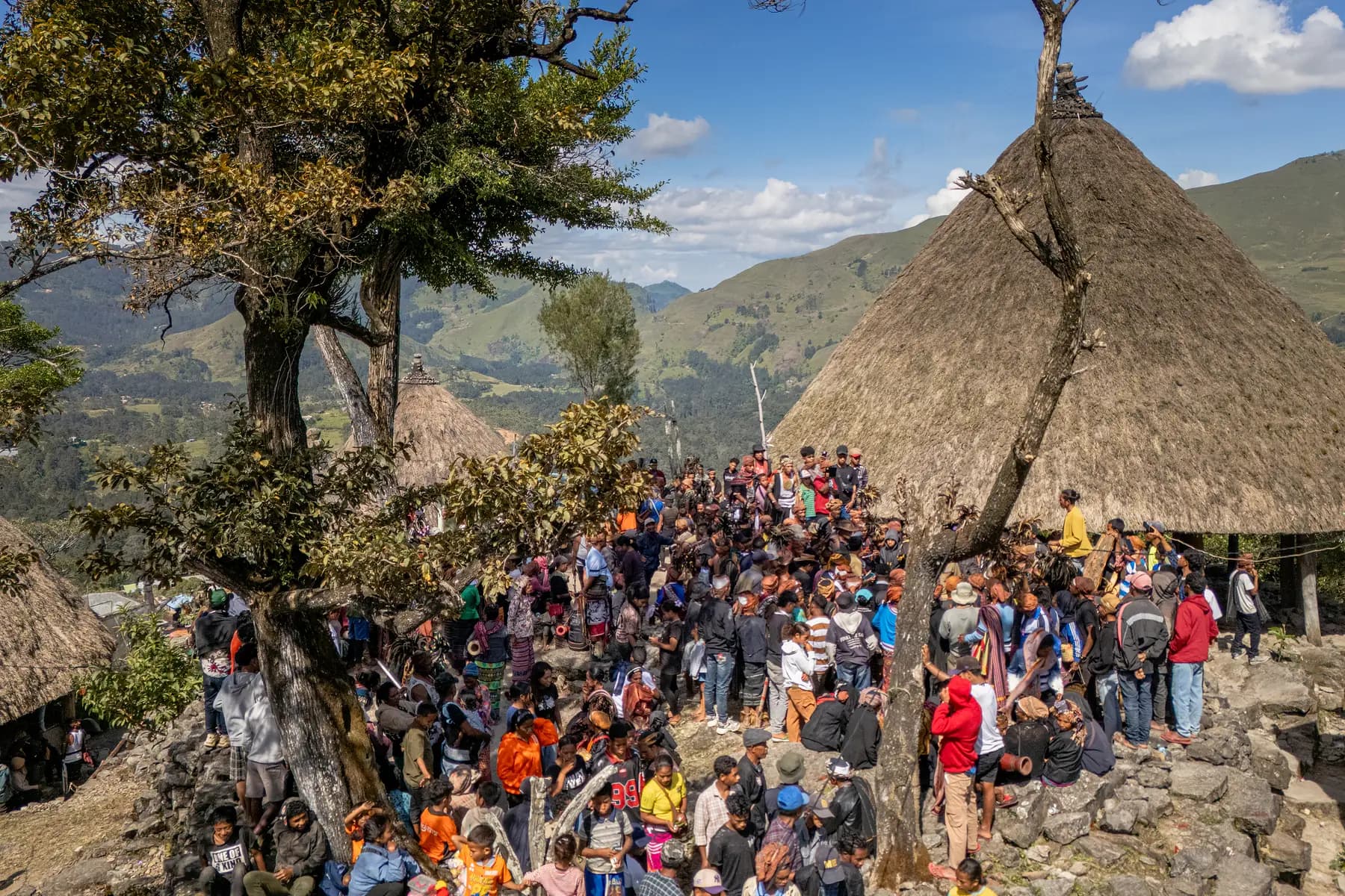 The community gathers below the sacred house for Tebe Fatuk