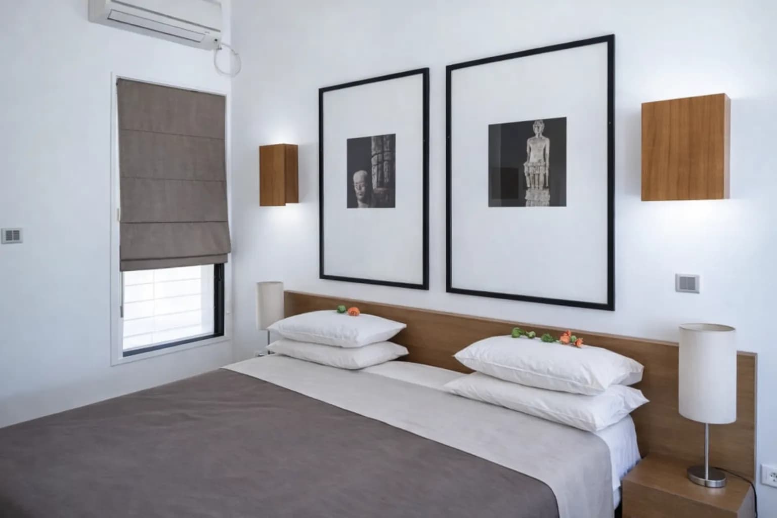 Double room with framed Timorese art and fresh flowers at Hotel Esplanada