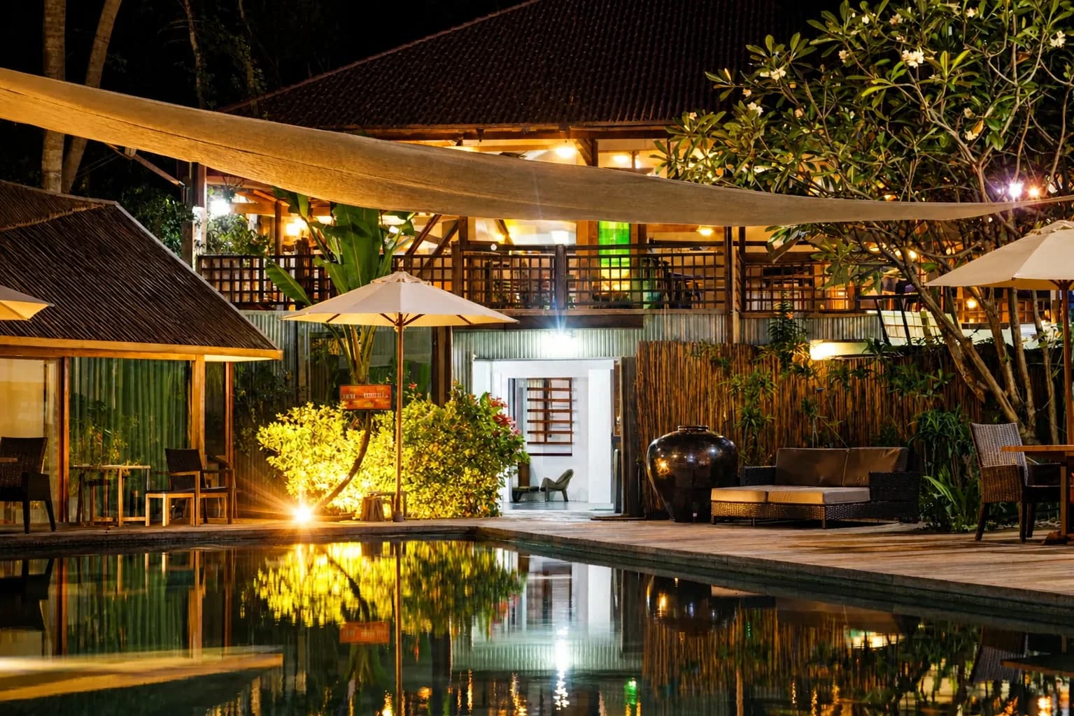 Pool and lantern-lit terrace at Hotel Esplanada after dark