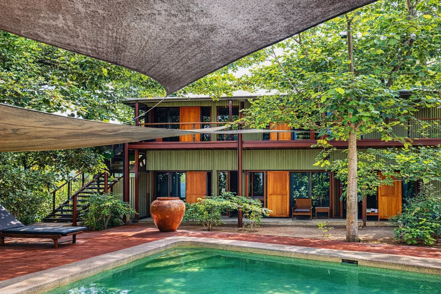 Hotel Esplanada building and swimming pool under shade sails in Dili