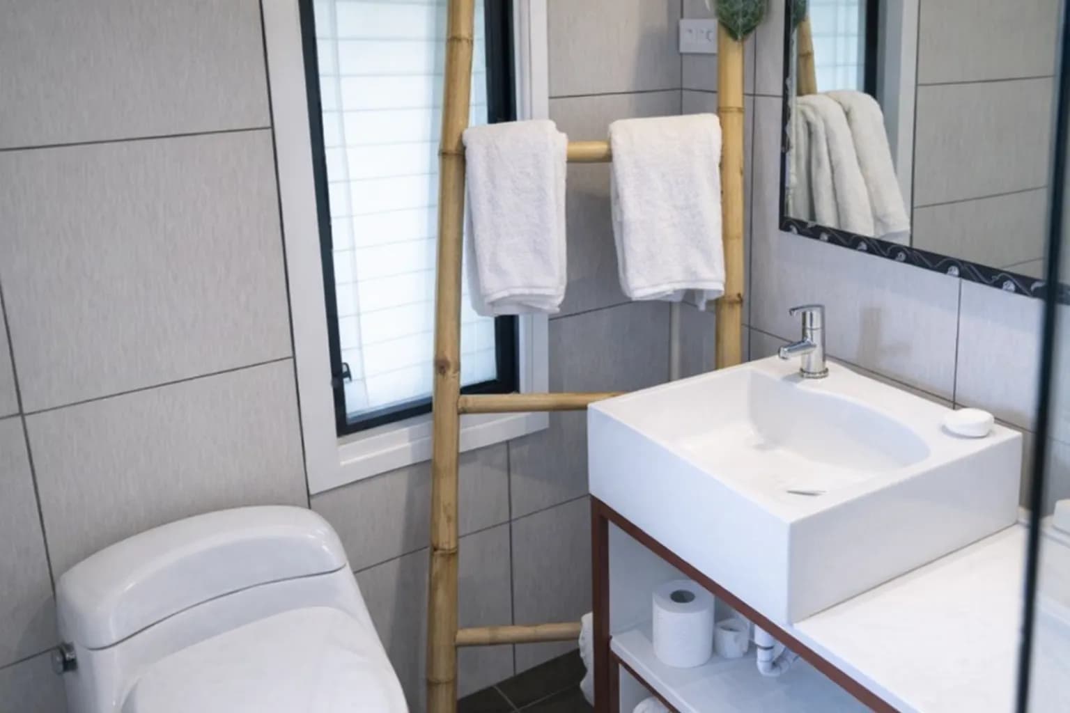 Private bathroom with bamboo towel rack at Hotel Esplanada