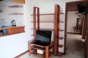 Arbiru Beach Resort room with TV cabinet against a wood-panelled feature wall