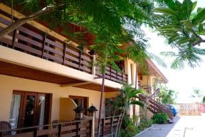Arbiru Beach Resort two-storey villa block with timber balconies and tropical plants
