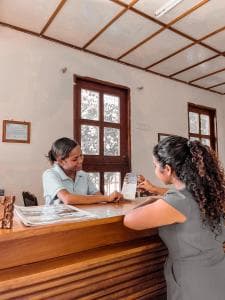 Arbiru Beach Resort reception with friendly staff and a guest checking in