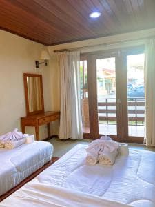 Arbiru Beach Resort suite with twin beds and french doors to balcony