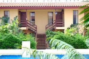 Arbiru Beach Resort villa block with covered porches and pool foreground