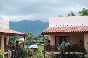 Arbiru Beach Resort terracotta-roof villas with mountain backdrop