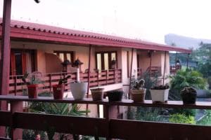Arbiru Beach Resort villa block with timber balcony and potted plants at sunset