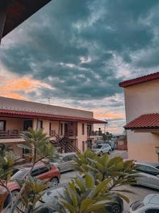 Arbiru Beach Resort dawn view of villa courtyard with parked cars