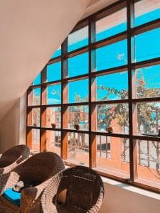 Arbiru Beach Resort window seat with arched window and rattan chairs