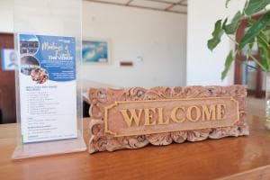 Arbiru Beach Resort carved 'Welcome' sign at reception