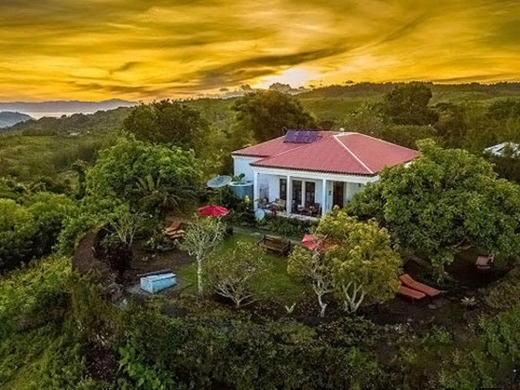 Balibo Fort Hotel hilltop villa silhouetted against an orange sunset sky