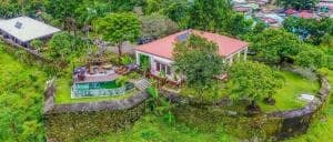 Balibo Fort Hotel hilltop villa with pool, viewed from above amid green countryside