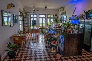 Balibo Fort Hotel common lounge with checkerboard tile floor and tropical plants