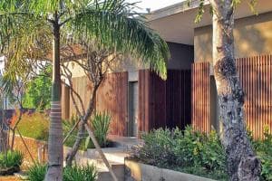 Balibo Fort Hotel timber screen exterior with palm trees