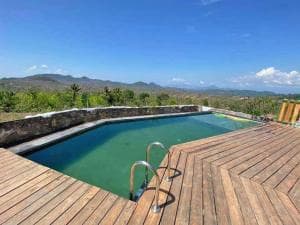 Balibo Fort Hotel rectangular pool with timber deck and panoramic landscape view