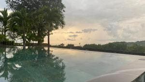Balibo Fort Hotel infinity pool reflecting palms at twilight
