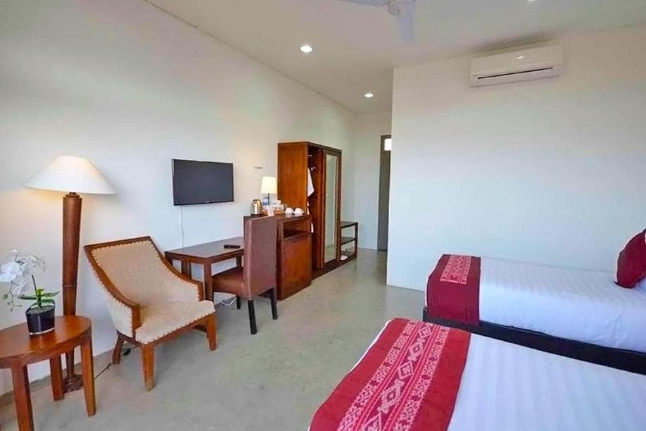 Balibo Fort Hotel suite with TV, work desk and twin beds