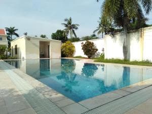Beach Garden Hotel pool with white villas behind and paved sun deck