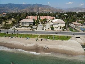 Beach Garden Hotel aerial view with beachfront and mountain backdrop