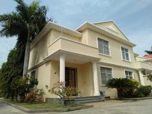 Beach Garden Hotel two-storey villa with portico entrance and tropical landscaping