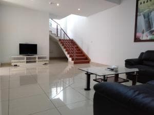 Beach Garden Hotel villa lounge with TV, staircase to upper floor and tile floor