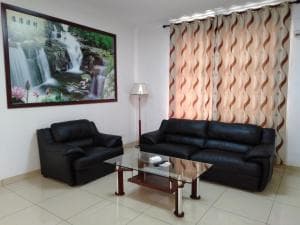 Beach Garden Hotel lounge with leather sofas and waterfall mural artwork