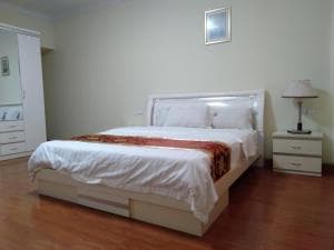 Beach Garden Hotel suite with king bed and bedside lamps in soft lighting