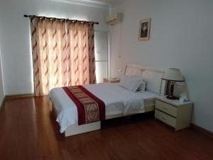 Beach Garden Hotel room with king bed and earth-toned curtains