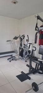 Beach Garden Hotel gym with treadmill, cross-trainer and weight machines