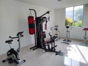 Beach Garden Hotel gym with cardio bike, weight station and exercise equipment