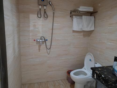 Chong Ti Hotel bathroom with shower partition and toilet