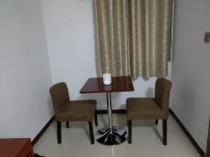 Chong Ti Hotel breakfast nook with table and tan chairs