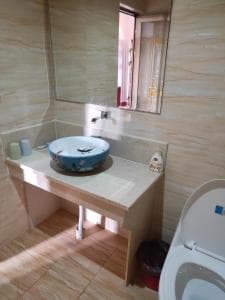Chong Ti Hotel bathroom vanity with vessel basin and tiled counter