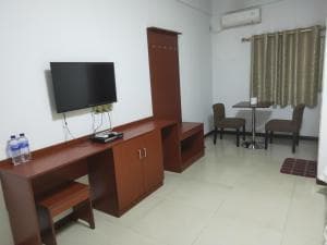 Chong Ti Hotel room sitting area with TV cabinet and small dining table
