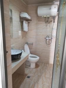 Chong Ti Hotel ensuite with walk-in shower and wall-mounted water heater