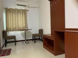 Chong Ti Hotel in-room sitting nook with two chairs and pedestal table