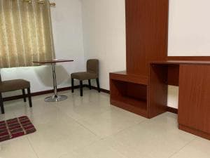 Chong Ti Hotel sitting area with two beige chairs and pedestal table