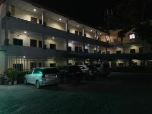 Chong Ti Hotel three-storey exterior at night with cars parked at entrance