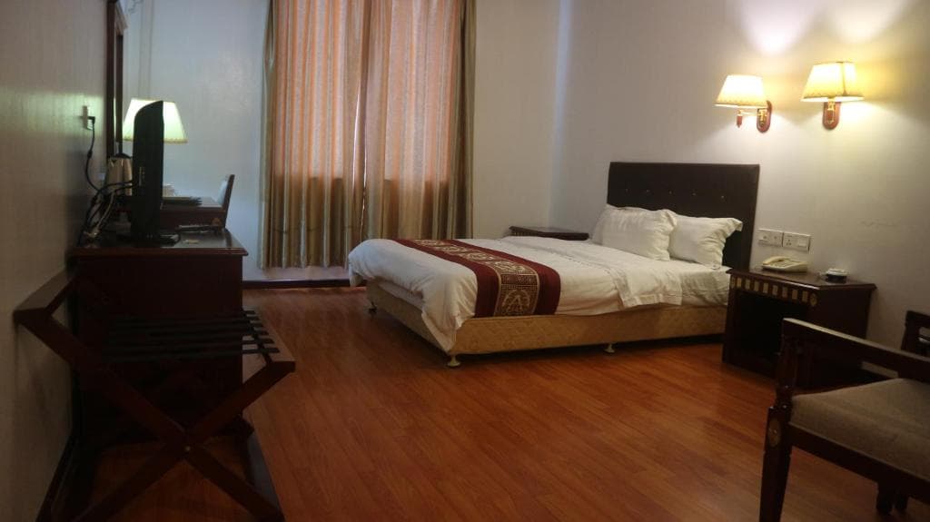 Excelsior Resort room with king bed and timber floors