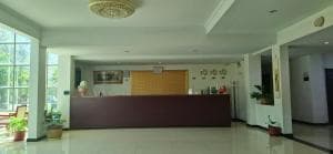 Excelsior Resort reception desk with green walls and tile floor