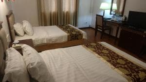 Excelsior Resort suite with king and twin beds, wood floors