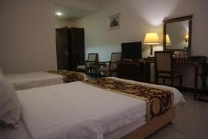 Excelsior Resort suite with single bed and dressing table