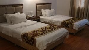 Excelsior Resort twin-bed room with patterned bed runners