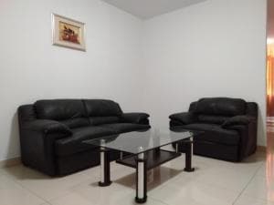 Excelsior Resort suite lounge area with leather sofas and framed art