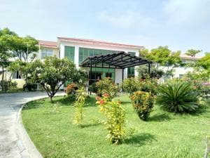 Excelsior Resort manicured garden with carport and palm trees