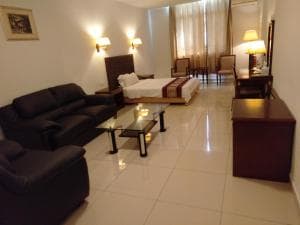 Excelsior Resort suite with king bed, lounge area and sofa