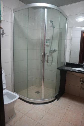 Excelsior Resort Standard Double Room bathroom with curved glass shower
