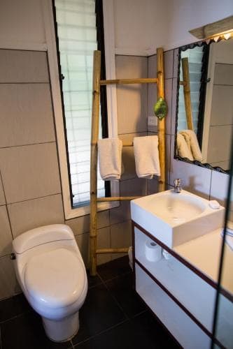 Hotel Esplanada en-suite bathroom with bamboo towel ladder and white wall-mounted sink